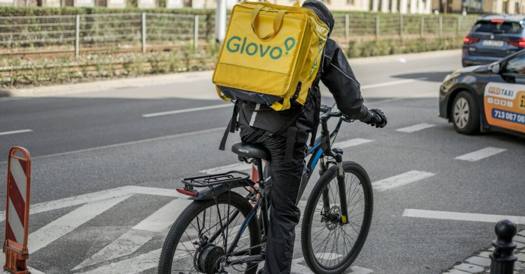 Cyclist delivering food in Wrocław, Poland, highlighting urban lifestyle and transportation.